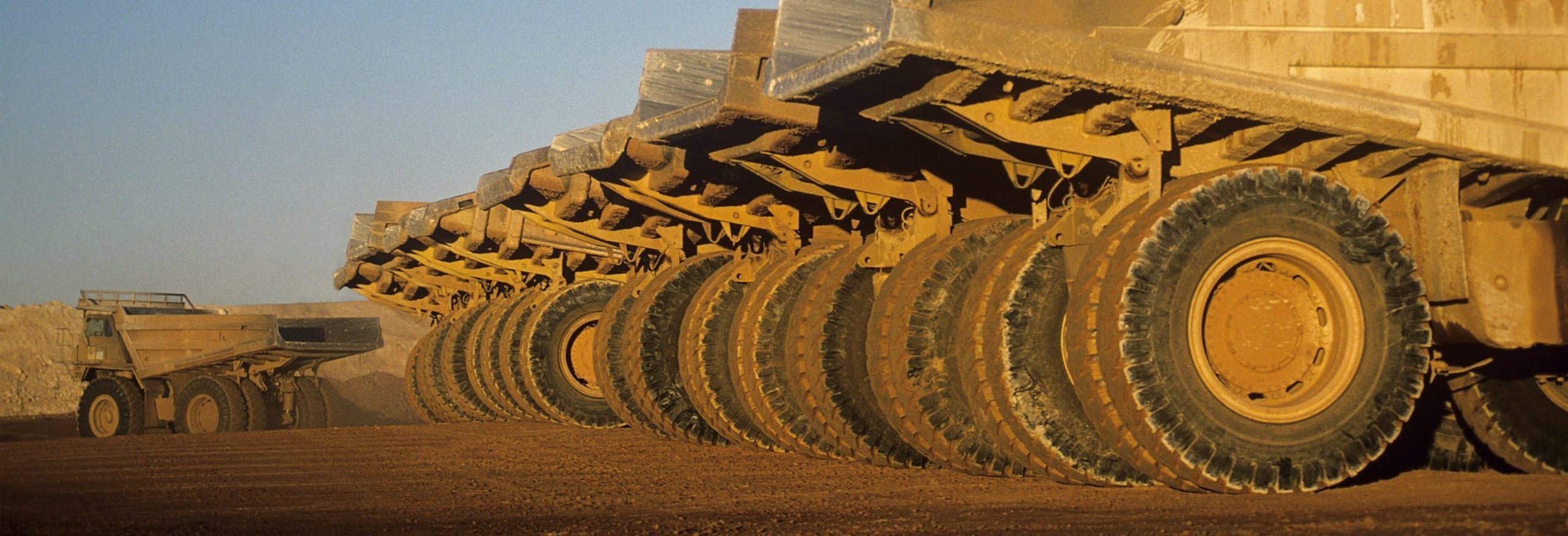 Ore hauling trucks in row, Telfer, Western Australia Off the Road (OTR) Tyres